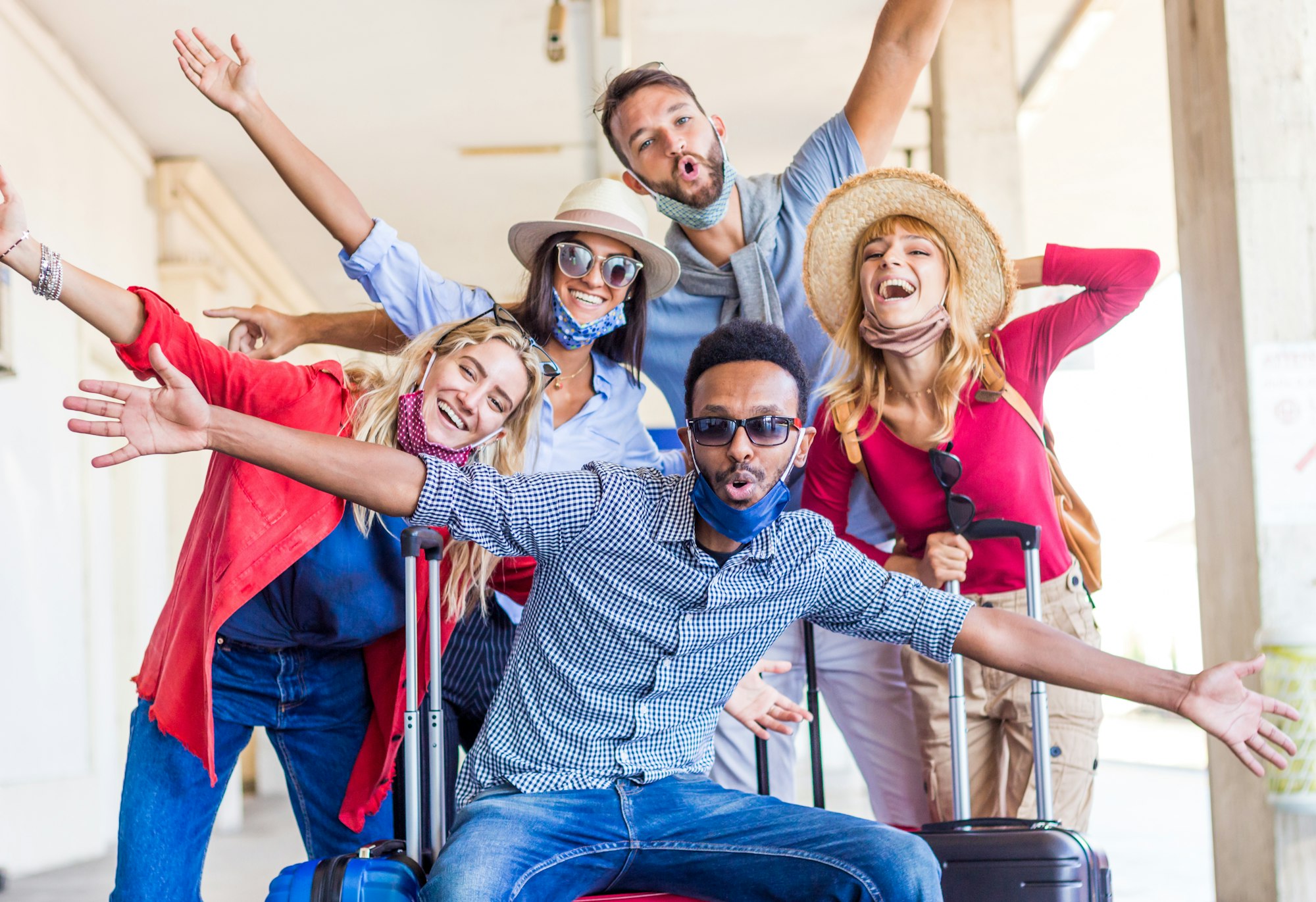 Multiracial group of friends at train station